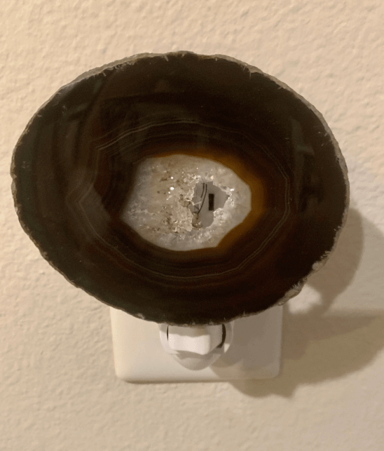 Black Brown agate crystal geode night light with natural patterns, adding a calming glow to any room