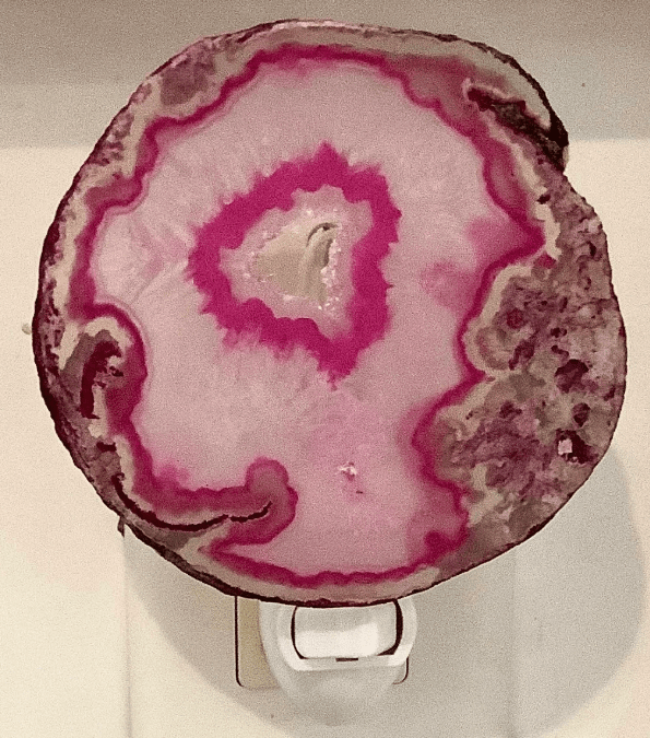 Pink agate crystal geode night light with natural patterns, adding a calming glow to any room